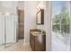 Bright bathroom with a glass-enclosed shower, marble-look vanity and tiled floors at 755 Cranes Court, Maitland, FL 32751