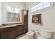 Full bathroom with a cabinet for storage, bidet, granite countertops and tiled shower at 755 Cranes Court, Maitland, FL 32751