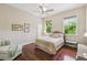 Comfortable bedroom featuring hardwood floors, neutral walls, and plenty of natural light at 755 Cranes Court, Maitland, FL 32751