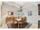Bright dining room features a modern chandelier, buffet table, and area rug under a wood table at 755 Cranes Court, Maitland, FL 32751