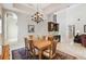 Elegant dining room with a chandelier, wooden table set, and a bar area; the perfect space for Gathering gatherings at 755 Cranes Court, Maitland, FL 32751