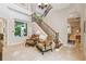 Bright foyer showcasing staircase, tile flooring, and seating area with comfortable chairs at 755 Cranes Court, Maitland, FL 32751