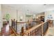 Hallway with hardwood floors, reading nook, bedroom access and wrought iron staircase at 755 Cranes Court, Maitland, FL 32751