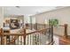 Second floor hallway with hardwood floors, windows, study, and wood with wrought iron railings at 755 Cranes Court, Maitland, FL 32751