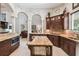 Gourmet kitchen with island, granite countertops, custom cabinets, and open floor plan for entertaining at 755 Cranes Court, Maitland, FL 32751