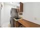 Efficient laundry room with a stacked washer/dryer and built-in folding counter and storage at 755 Cranes Court, Maitland, FL 32751