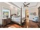 Spacious main bedroom with a four-poster bed, wood floors, and a view to the ensuite bathroom at 755 Cranes Court, Maitland, FL 32751