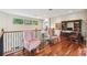 Bright upper landing features a library, desk, and sitting area with hardwood floors at 755 Cranes Court, Maitland, FL 32751