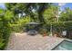 Outdoor patio with a dining set, a grill, and privacy-enhancing hedges at 755 Cranes Court, Maitland, FL 32751