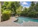An inviting in-ground pool with surrounding patio and lush greenery, ideal for relaxation at 755 Cranes Court, Maitland, FL 32751