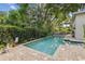 Beautiful in-ground pool with a spacious patio and lush greenery, perfect for relaxation at 755 Cranes Court, Maitland, FL 32751