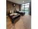 Bright bedroom with large window featuring two beds, an industrial style clock, and wood accent wall at 7567 Brooklyn Dr, Kissimmee, FL 34747