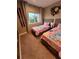 Charming bedroom featuring two beds with themed bedding, a window with natural light, and cozy carpet at 7567 Brooklyn Dr, Kissimmee, FL 34747
