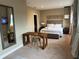 Spacious bedroom with a wooden desk, cozy chair, and a mounted TV, offering a comfortable and functional living space at 7567 Brooklyn Dr, Kissimmee, FL 34747