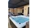Inviting hot tub with lounge seating and dining area under a covered patio at 7567 Brooklyn Dr, Kissimmee, FL 34747