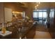 Open concept kitchen features stainless steel sink, custom cabinetry, and view to the living room at 7567 Brooklyn Dr, Kissimmee, FL 34747
