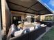 Beautiful covered patio with comfortable seating, a grill, and a hot tub for relaxing and entertaining at 7567 Brooklyn Dr, Kissimmee, FL 34747