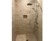 Sleek shower featuring neutral herringbone tile and a built-in niche for convenient storage at 7567 Brooklyn Dr, Kissimmee, FL 34747