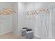 A tidy closet featuring wire shelving, wooden hangers, white bathrobes, and grey laundry baskets at 786 Mocking Jay Ln, St Cloud, FL 34771