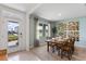 Bright dining room with large window, modern decor, and a view of the home's exterior at 786 Mocking Jay Ln, St Cloud, FL 34771