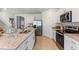 Modern kitchen featuring granite countertops, stainless steel appliances, and ample counter space at 786 Mocking Jay Ln, St Cloud, FL 34771