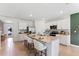 Modern kitchen featuring granite countertops, white cabinetry, and a center island with barstool seating at 786 Mocking Jay Ln, St Cloud, FL 34771