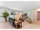 Inviting living room featuring a comfortable green sofa, natural light, and stylish decor at 786 Mocking Jay Ln, St Cloud, FL 34771