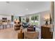 Open-concept living room with a modern kitchen, comfortable seating, and ample natural light at 786 Mocking Jay Ln, St Cloud, FL 34771