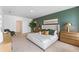Elegant primary bedroom with a green accent wall, comfortable bed, and tasteful decor at 786 Mocking Jay Ln, St Cloud, FL 34771