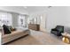 Bright primary bedroom with a comfortable bed, natural light, and a stylish accent chair at 786 Mocking Jay Ln, St Cloud, FL 34771