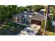 Aerial view of a single-story home featuring a rock garden, covered entryway, and a two-car garage at 814 Vercelli St, Deltona, FL 32725