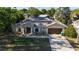 Aerial view of a single-story home featuring a rock garden, covered entryway, and a two-car garage at 814 Vercelli St, Deltona, FL 32725