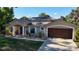 Single-story home featuring a rock garden, covered entryway with columns, and a two-car garage at 814 Vercelli St, Deltona, FL 32725