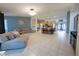 Open-concept living room flows into kitchen with stainless steel appliances and breakfast bar seating at 814 Vercelli St, Deltona, FL 32725