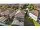 An aerial view of a home with a screened in pool and view of the tile roof at 8961 Rhodes St, Kissimmee, FL 34747