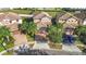 Aerial view of home, featuring tile roof, lush landscaping and paved driveway at 8961 Rhodes St, Kissimmee, FL 34747