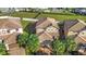 Aerial view of the property featuring tile roof, palm trees and manicured lawn at 8961 Rhodes St, Kissimmee, FL 34747