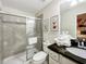 Bathroom featuring tiled shower, toilet, single sink vanity, and animated animal art at 8961 Rhodes St, Kissimmee, FL 34747