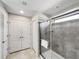 Modern bathroom featuring a glass-enclosed shower with tile and dual closets at 8961 Rhodes St, Kissimmee, FL 34747