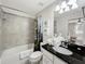 Bathroom featuring shower/tub combination, toilet, single sink vanity, and swan towel art at 8961 Rhodes St, Kissimmee, FL 34747