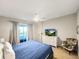 Comfortable bedroom with TV has a ceiling fan, neutral walls and carpet at 8961 Rhodes St, Kissimmee, FL 34747