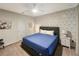 Comfortable bedroom boasts a stylish accent wall, cozy decor, and soft natural light at 8961 Rhodes St, Kissimmee, FL 34747