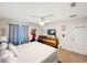 Bright bedroom featuring nautical decor, a ceiling fan, and a comfortable bed at 8961 Rhodes St, Kissimmee, FL 34747