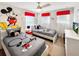bedroom featuring Mickey Mouse-themed décor, two twin beds, and a bright, cheerful ambiance at 8961 Rhodes St, Kissimmee, FL 34747