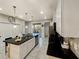 Bright kitchen features a large island with black countertops and white cabinets, plus stainless steel appliances at 8961 Rhodes St, Kissimmee, FL 34747