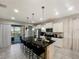 This spacious kitchen offers a center island with bar seating, bright white cabinets and stainless steel appliances at 8961 Rhodes St, Kissimmee, FL 34747