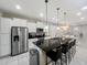 A modern kitchen boasts a large island with seating and stainless steel appliances at 8961 Rhodes St, Kissimmee, FL 34747