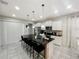 A modern kitchen boasts a large island with seating and white cabinets at 8961 Rhodes St, Kissimmee, FL 34747