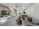 A modern living room features tile floors, a gray sectional couch, and ample natural light at 8961 Rhodes St, Kissimmee, FL 34747