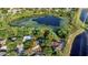 Overhead view of home and surrounding land highlighting its proximity to a serene lake at 9290 Lake Sharp Ct, Orlando, FL 32817